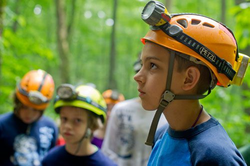 Tucker Bush listens to instructions from the Georgia Girl Guides leading their expedition inside Sitton's Cave at Cloudland Canyon State Park in Rising Fawn, Georgia on Tuesday, June 18, 2013.