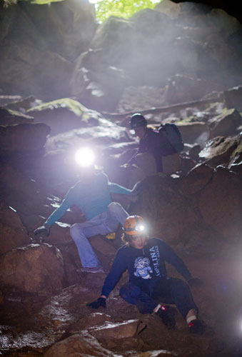 William Dusenbury (bottom), Matt Schmitz and Christine Rose make their way down the entrance of Sitton's Cave in Cloudland Canyon State Park in Rising Fawn, Georgia as part of Decatur-based Camp Scene Environmental Adventures' summer camp on Tuesday, June 18, 2013. 