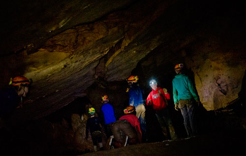 Georgia Girl Guide Amy Ward (center) waits for campers to catch up as they explore a section of Sitton's Cave in Cloudland Canyon State Park in Rising Fawn, Georgia as part of Decatur-based Camp Scene Environmental Adventures' summer camp on Tuesday, June 18, 2013.