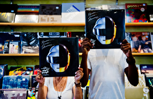 Maria Alcantara and Jonathan Johnson hold records as they goof around inside Criminal Records in the Little Five Points neighborhood in Atlanta on Saturday, July 27, 2013.