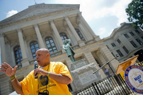Gerald Rose (left) chants into a microphone during the Trayvon Martin Rally at the Georgia State Capitol in Atlanta on Sunday, July 28, 2013. 