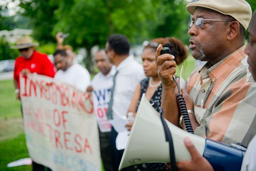 Michael James (right) speaks during the We Are Here Rally for Respect in Rememberance of Teresa Weaver Pickard at Piedmont Park in Atlanta on Wednesday, June 26, 2013. 