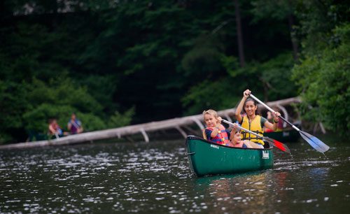 Alex Kleinkauf (left), Luke Allen and Alia Nikooforsat paddle their canoe on one of the three ponds at the Chattahoochee Nature Center in Roswell during Camp Kingfisher on Wednesday, June 5, 2013.