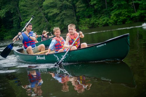 Matty Scalo (right) Chase Connor and Hudson Tsay paddles race across one of the three ponds at the Chattahoochee Nature Center in Roswell in a canoe during Camp Kingfisher on Wednesday, June 5, 2013.