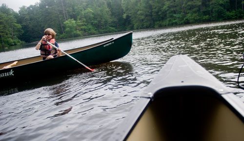 Emerson Adcock (left) paddles his canoe on one of the three ponds at the Chattahoochee Nature Center in Roswell during Camp Kingfisher on Wednesday, June 5, 2013. 