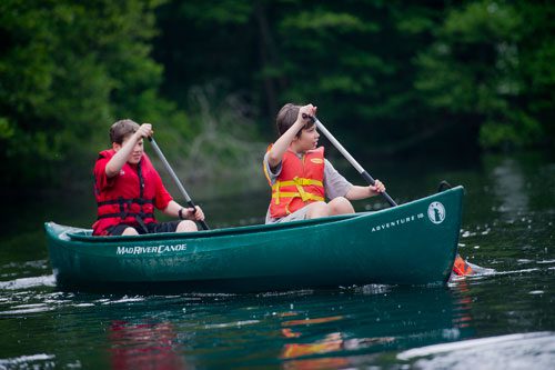 Leo Nayshtut (right) and Jake Smith paddle their canoe on one of the three ponds at the Chattahoochee Nature Center in Roswell during Camp Kingfisher on Wednesday, June 5, 2013.