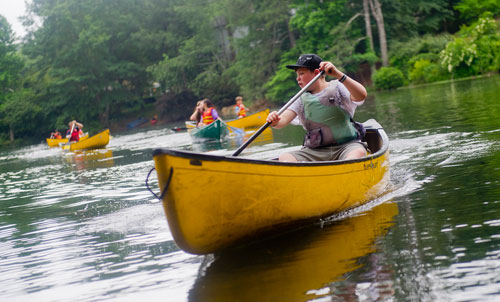 Patrick Fletcher paddles his canoe on one of the three ponds at the Chattahoochee Nature Center in Roswell during Camp Kingfisher on Wednesday, June 5, 2013. 