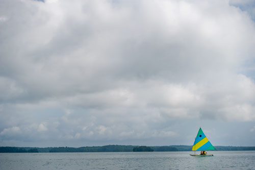 Christian Hagen (left), Austin Chastain and Alex Foster sail their sunfish sailboat across Lake Lanier during Lord Nelson Charters' Summer Sailing Camp in Buford on Tuesday, July 9, 2013. 
