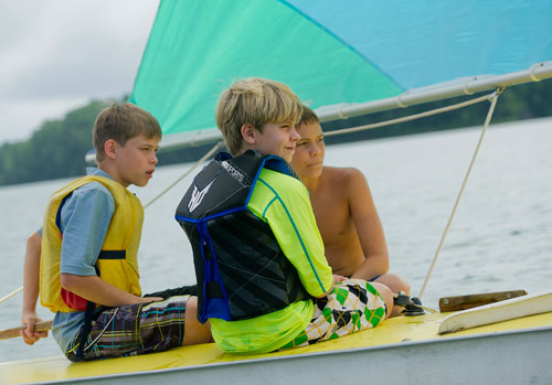 Foster (left) and Austin Chastain (right) listen to directions from Christian Hagen as they sail their sunfish sailboat across Lake Lanier during Lord Nelson Charters' Summer Sailing Camp in Buford on Tuesday, July 9, 2013. 