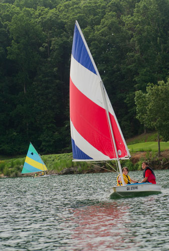 Paul Fiorillo (right) and Jack Tilinski sail their sunfish sailboat across Lake Lanier during Lord Nelson Charters' Summer Sailing Camp in Buford on Tuesday, July 9, 2013.