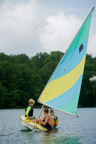 Austin Chastain (left), Christian Hagen and Alex Foster sail their sunfish sailboat across Lake Lanier during Lord Nelson Charters' Summer Sailing Camp in Buford on Tuesday, July 9, 2013. 