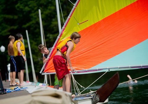 Parks Barnard (right) and Chase Hart break down the sail and mast on their sunfish sailboat during Lord Nelson Charters' Summer Sailing Camp at Lake Lanier in Buford on Tuesday, July 9, 2013. 
