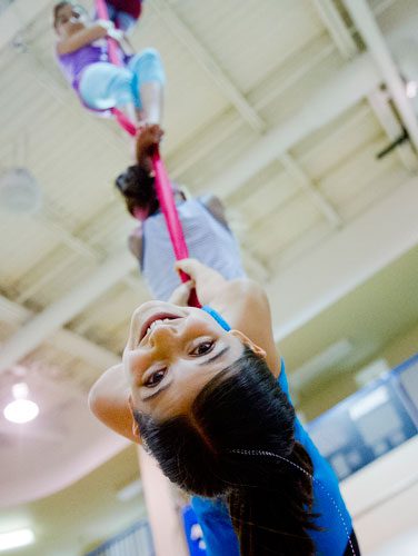 Ariel Scher hangs from silks during Circus Summer Camp at Davis Academy in Dunwoody on Wednesday, July 10, 2013. 