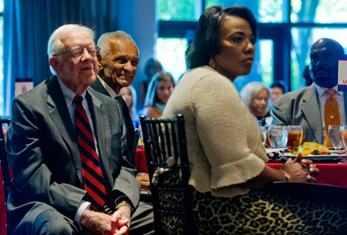 Rev. C.T. Vivian (center), former President Jimmy Carter and Rev. Bernice King listen to speakers during America's Sunday Supper at the Carter Center in Atlanta on Sunday, August 11, 2013. 