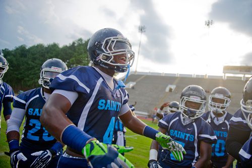 Cedar Grove's Bryson Allen-Williams (center) gets his teammates pumped before their game against Tucker at Panthersville Stadium in Decatur on Friday, August 23, 2013.