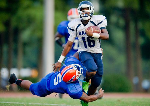 Cedar Grove's Deion Sellers (16) breaks a tackle by Columbia's Montrez Johnson (5) as he runs down the field with the ball during their game at Panthersville Stadium in Decatur on Friday, August 30, 2013.