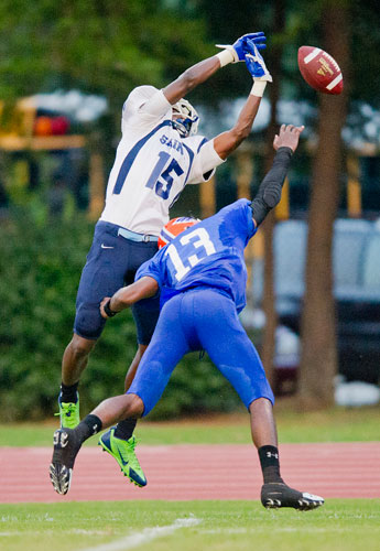 Cedar Grove's Brandon Norwood (15) reaches up to try and catch the ball as Columbia's Ken Hike (13) breaks up the play during their game at Panthersville Stadium in Decatur on Friday, August 30, 2013. 