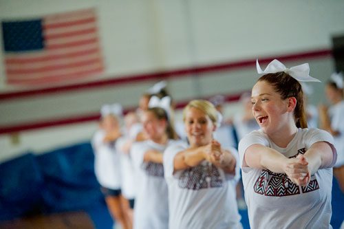 Connor Stanley (right) performs different cheers with her squad during cheerleading practice at Northgate High School in Newnan on Tuesday, August 20, 2013.