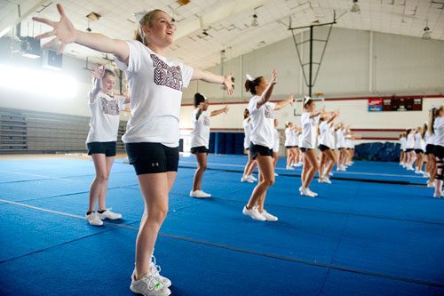 Morgan Mulvany (left) performs different cheers with her squad during cheerleading practice at Northgate High School in Newnan on Tuesday, August 20, 2013.