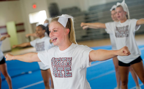 Chelsea Spates (center) performs different cheers with her squad during cheerleading practice at Northgate High School in Newnan on Tuesday, August 20, 2013. 