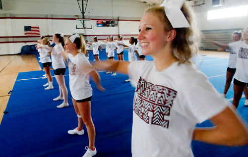 Taylor Mansukhani (right) performs different cheers with her squad during cheerleading practice at Northgate High School in Newnan on Tuesday, August 20, 2013.