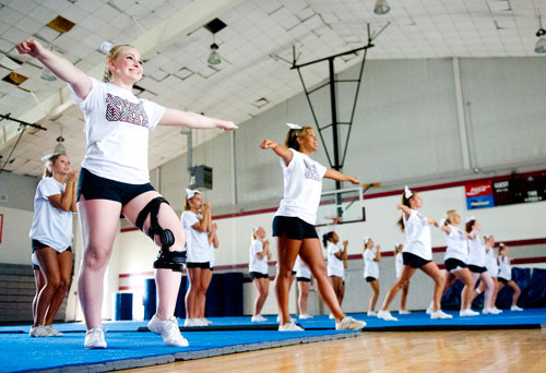 Montana Cole (left) performs different cheers with her squad during cheerleading practice at Northgate High School in Newnan on Tuesday, August 20, 2013. 