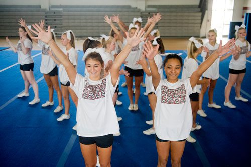 Sydney Greer (left) and Jada Ware run through their routine with the rest of the varsity squad during cheerleading practice at Northgate High School in Newnan on Tuesday, August 20, 2013. 