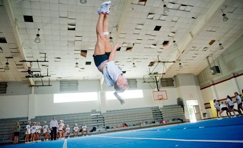 Chelsea Spates flips in the air during cheerleading practice at Northgate High School in Newnan on Tuesday, August 20, 2013.
