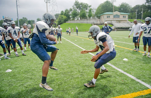 Norcross' Jeremiah Murphy (left) tries to juke past Malcolm Galloway during practice on Wednesday, August 21, 2013. 