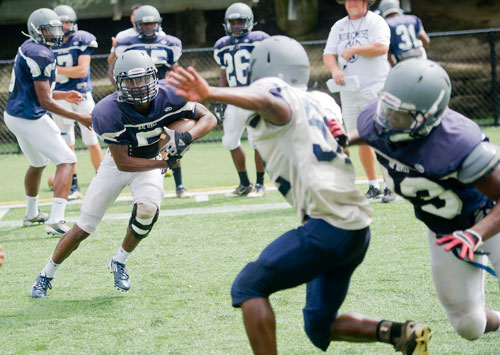 Norcross' Myles Autry (left) runs a play during practice on Wednesday, August 21, 2013. 
