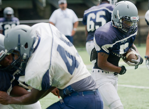 Norcross' Myles Autry (right) runs a play during practice on Wednesday, August 21, 2013. 