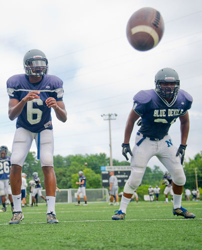 Norcross' A.J. Bush (left) is hiked the ball as he runs a play with James Keeling during practice on Wednesday, August 21, 2013. 