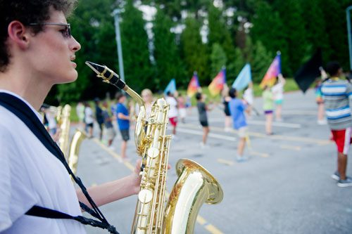 Jacob Martinez (left) holds his saxophone up as he participates in drills during marching band practice at Centennial High School in Roswell on Thursday, August 22, 2013.