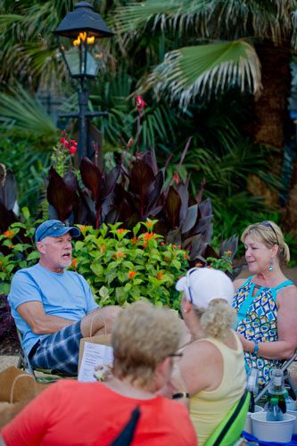 Brad Dean (left) talks with his wife Ann Broadaway as theyw ait for the Boz Scaggs concert to start at the Atlanta Botanical Gardens on Friday, July 19, 2013.