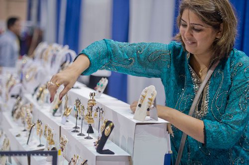 Surbhi Pagar sets up her jewelry diplay during the 17th annual Festival of India at the Gwinnett Center in Duluth on Saturday, August 24, 2013. 