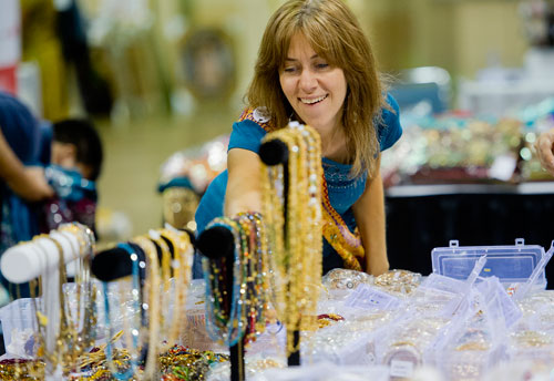 Gwen Dudek looks at pieces of jewelry for sale during the 17th annual Festival of India at the Gwinnett Center in Duluth on Saturday, August 24, 2013. 