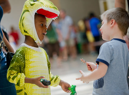 Jonathan Skeete (left) and Kaleb Hess play with their dinosaur toys at the Fernbank Museum of Natural History in Atlanta as part of the 12th anniversary of Giants of the Mesozoic on Saturday, August 24, 2013.