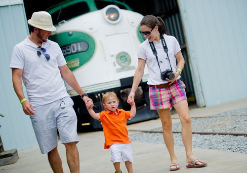 Lincoln Nunnally (left) and his wife Rebekah hold hands with their son Reagan as they walk around during Trains, Trucks and Tractors at the Southeastern Railway Museum in Duluth on Saturday, August 3, 2013. 