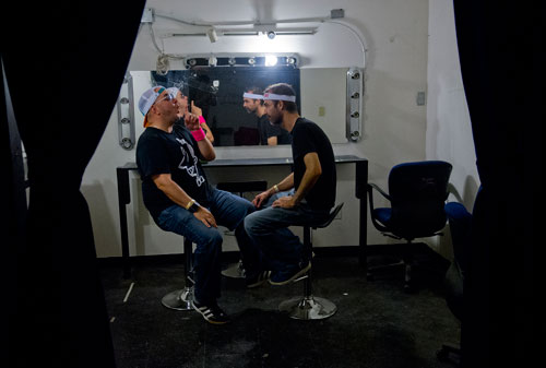 Jed Broitman (left) and Matt Stanton, two of the founders of Dad's Garage, talk in the dressing room during the Bringing Down the House Party at Dad's Garage in Atlanta on Saturday, August 3, 2013. 