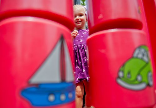 Zoe Tobiasz plays on the playground at Thrasher Park in Norcross on Thursday, August 8, 2013.