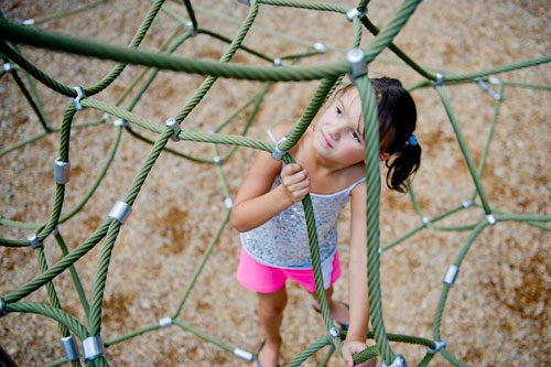 Sophie Haney climbs on the playground at Caney Creek Preserve in Cumming on Friday, August 9, 2013.