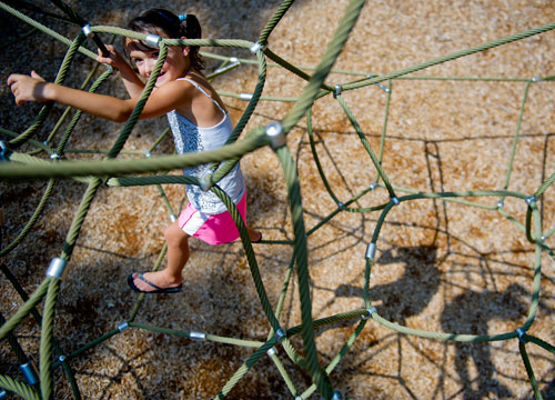 Sophie Haney climbs on the playground at Caney Creek Preserve in Cumming on Friday, August 9, 2013. 