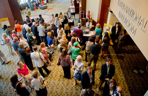 State legislators from all over the nation stand in line along with others to register for the 2013 National Conference of State Legislators at the Omni Hotel in Atlanta on Sunday, August 11, 2013.