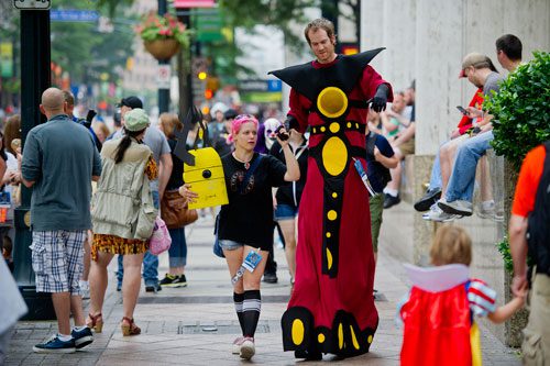 Danielle Weisgerber (left) holds her husband Patrick's hand as they make their way to the staging area for the annual DragonCon parade through downtown Atlanta on Saturday, August 31, 2013.