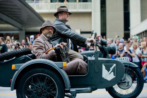 Dressed in Indiana Jones garb, Jason Antonelli (left) and Joseph Moran steer a motorcycle in the annual DragonCon parade through downtown Atlanta on Saturday, August 31, 2013. 