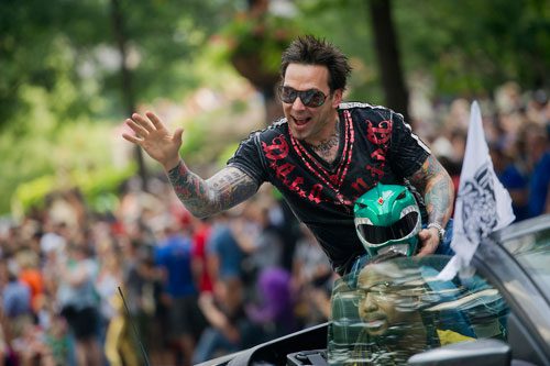 Known for his role as the Green Power Ranger, Jason David Frank waves to the crowd as he makes his way down Peachtree Street in the annual DragonCon parade through downtown Atlanta on Saturday, August 31, 2013.