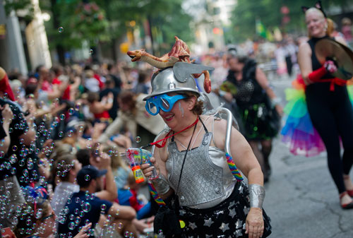 Fern Garber blows bubbles at the crowd as she marches in the annual DragonCon parade through downtown Atlanta on Saturday, August 31, 2013. 