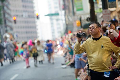 Dressed in Star Trek garb, Joe Cepeda uses a video camera to record the annual DragonCon parade through downtown Atlanta on Saturday, August 31, 2013.