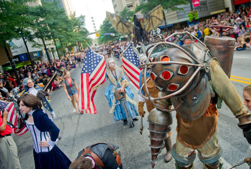 Dressed as Big Daddy, a character from the video game Bio Shock, Zach Krohne (right)  marches in the annual DragonCon parade through downtown Atlanta on Saturday, August 31, 2013. 