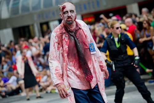 Dressed as a zombie, Stan Bowman marches in the annual DragonCon parade through downtown Atlanta on Saturday, August 31, 2013. 